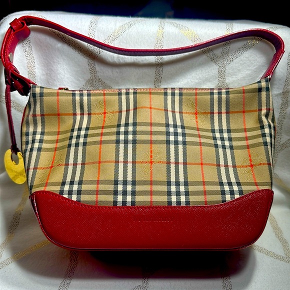 Small Burberry handbag with gold Burberry charm on the side. - Picture 1 of 4